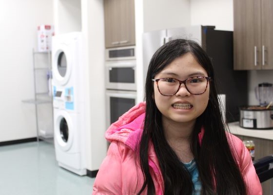 Student smiling standing in the transition lab
