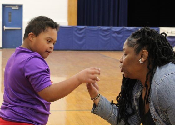Teacher providing hands-on instruction to a student 